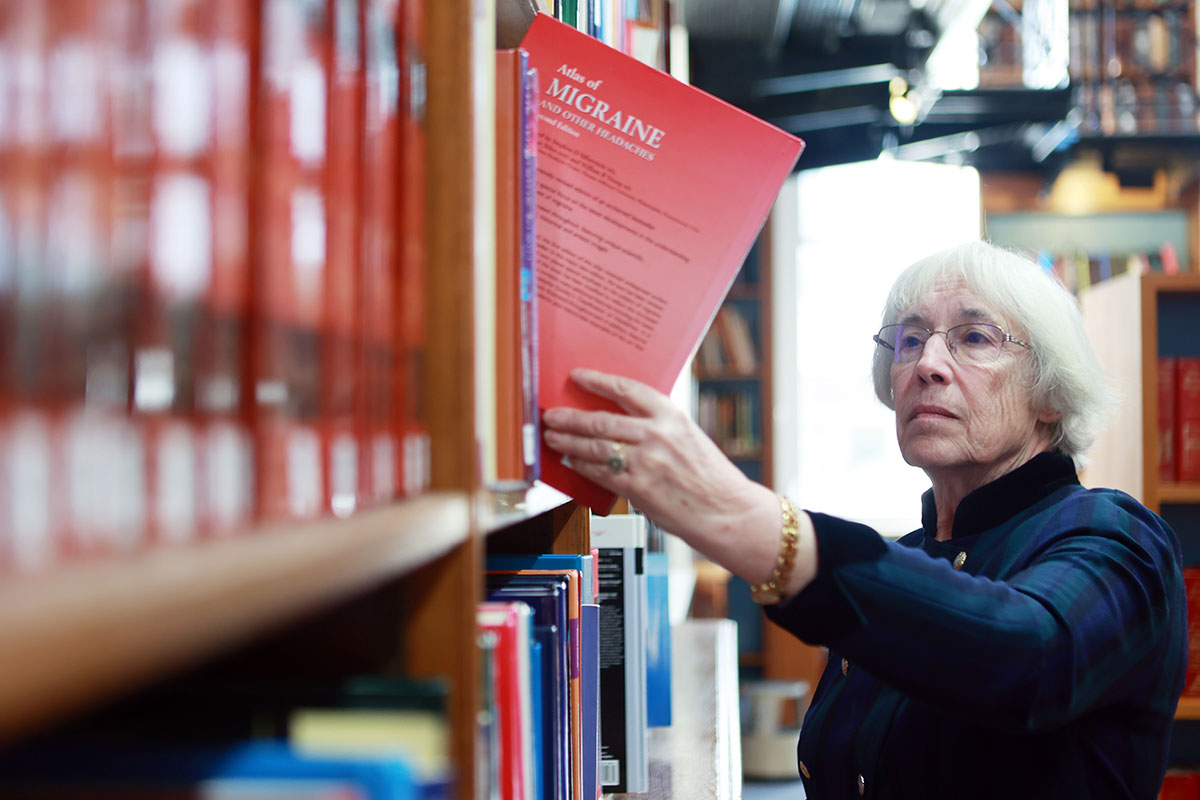 Taking book from shelf