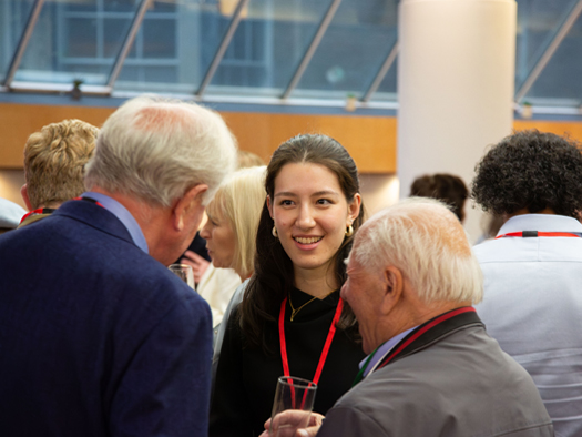 Young women speaking to two older men - Promo